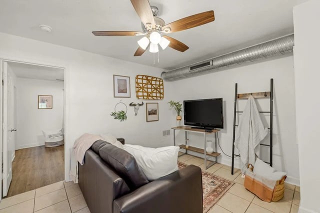 Sofa television ladder and artwork living room at Villa Cristina in Tallahassee Student Accommodation