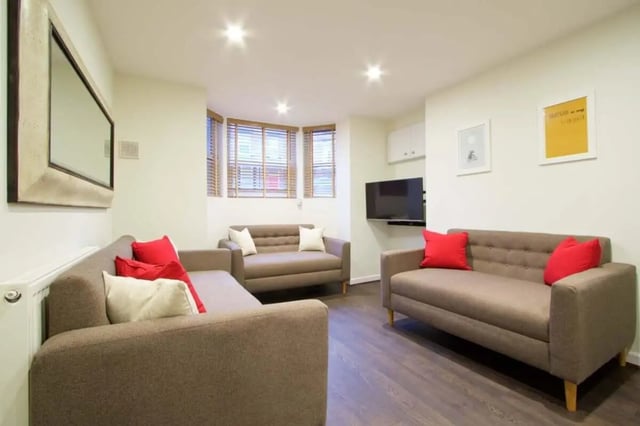 Sofas red and white pillows TV living room at 10 Brudenell Mount in Leeds Student Accommodation