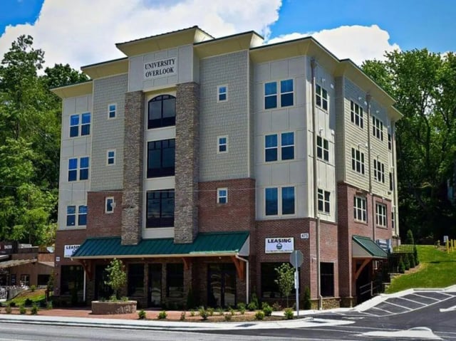 University Overlook building exterior with windows and brick. at Highland Woods Apartments of Boone in Boone Student Accommodation
