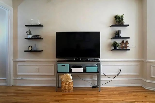 TV stand with boxes and basket living room at The Legacy at Drexel Arms Apartments in Philadelphia Student Accommodation