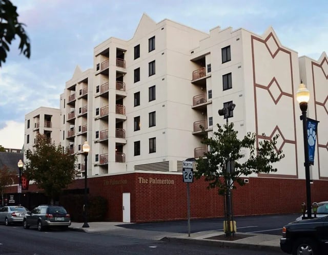 Apartment building with balconies and brick exterior exterior at Palmerton Apartment Complex in State College Student Accommodation