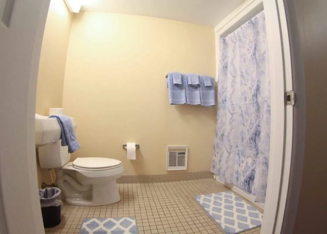Toilet towels bath curtain rug bathroom at Palmerton Apartment Complex in State College Student Accommodation