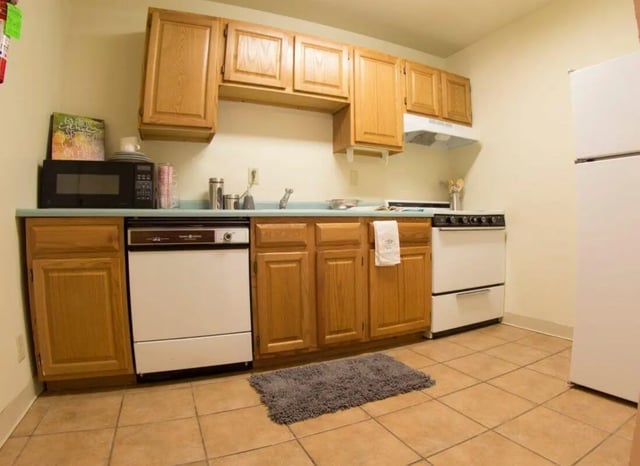 Microwave dishwasher stove refrigerator kitchen at Sutton Court in State College Student Accommodation