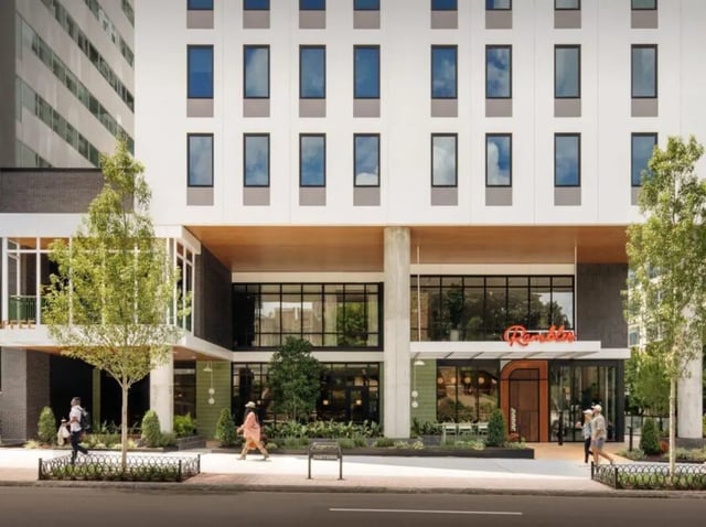 Modern building entrance with trees and people exterior at Rambler Atlanta Apartments in Atlanta Student Accommodation
