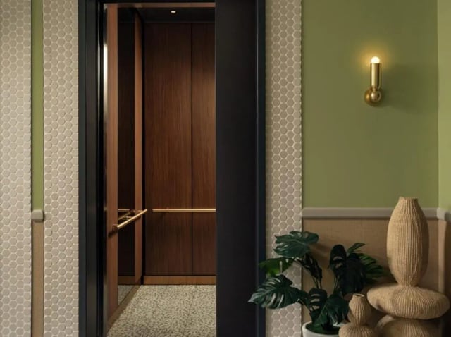 Elevator interior with wood paneling and brass rail Exterior at Rambler Atlanta Apartments in Atlanta Student Accommodation