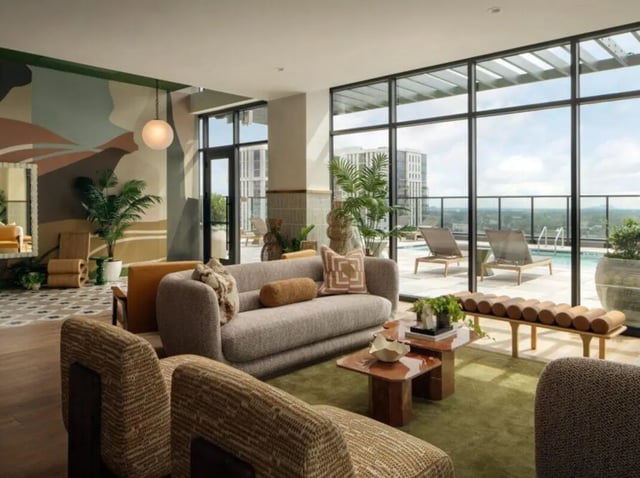 Sofa coffee tables plants and lounge chairs living room at Rambler Atlanta Apartments in Atlanta Student Accommodation