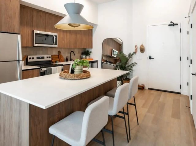 Kitchen island with seating and appliances kitchen at Rambler Atlanta Apartments in Atlanta Student Accommodation