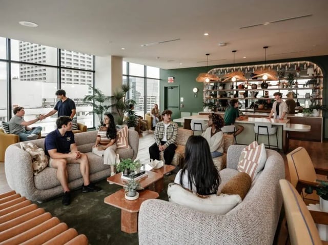 Students relaxing on couches in a lounge at Rambler Atlanta Apartments in Atlanta Student Accommodation