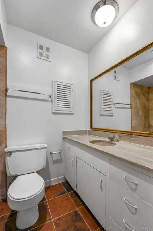 White toilet vanity mirror sink bathroom at University Terrace Apartments in State College Student Accommodation
