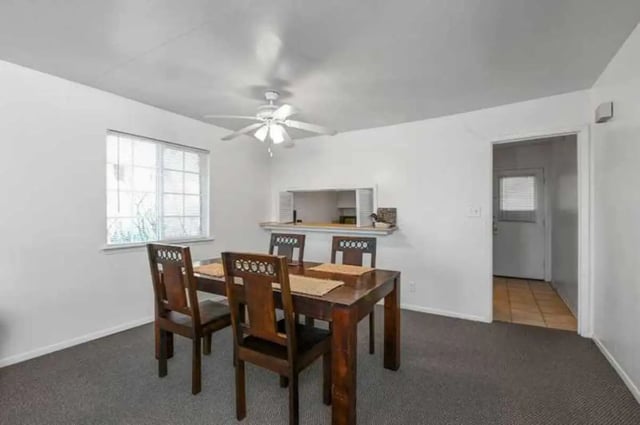 Wooden dining table four chairs serving hatch dining area at University Terrace Apartments in State College Student Accommodation