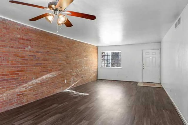 Brick wall ceiling fan empty room and door living room at University Terrace Apartments in State College Student Accommodation