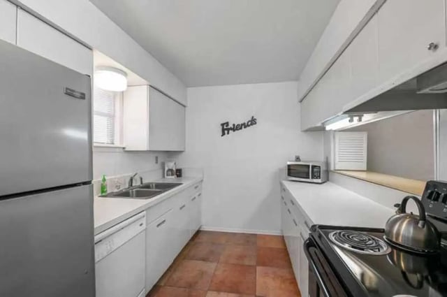Stainless steel fridge dishwasher sink microwave kettle kitchen at University Terrace Apartments in State College Student Accommodation