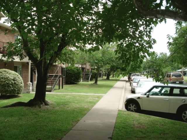 Apartment buildings with exterior stairs and parked cars exterior at University Terrace Apartments in State College Student Accommodation