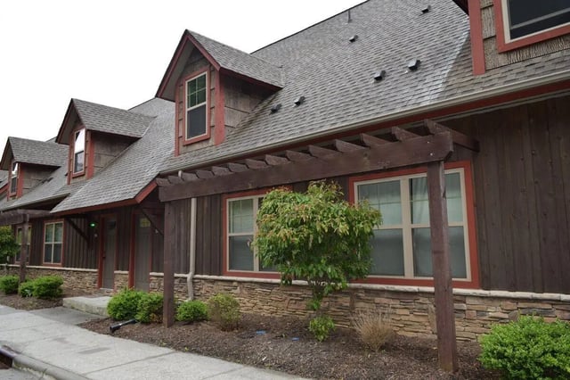 Wood building with dormers and small trees exterior at Forrest Edge Townhomes in Boone Student Accommodation