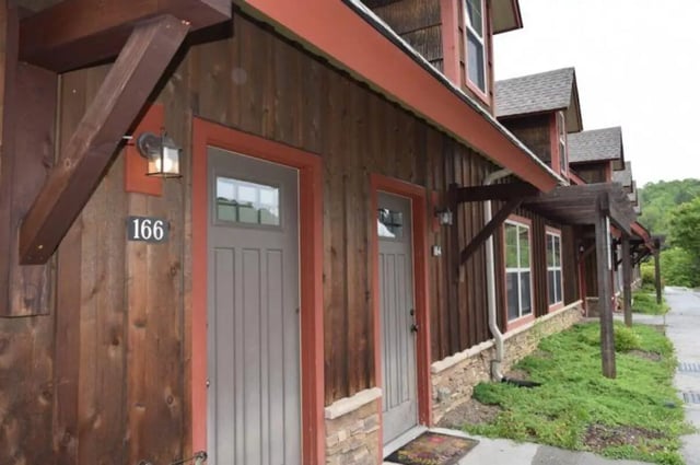 Wood sided building with gray doors exterior at Forrest Edge Townhomes in Boone Student Accommodation