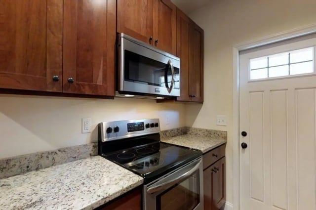 Stainless steel microwave wooden cabinets and oven kitchen at Forrest Edge Townhomes in Boone Student Accommodation