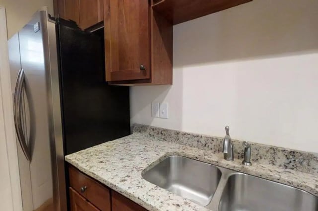 Stainless steel refrigerator double sink granite countertop kitchen at Forrest Edge Townhomes in Boone Student Accommodation