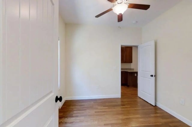 Wooden floor ceiling fan opens to kitchen bedroom at Forrest Edge Townhomes in Boone Student Accommodation