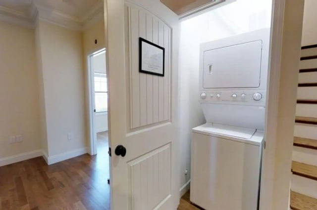 Stacked white washer dryer next to stairs Laundry room at Forrest Edge Townhomes in Boone Student Accommodation