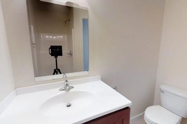 Sink toilet and shower reflected in mirror bathroom at Forrest Edge Townhomes in Boone Student Accommodation