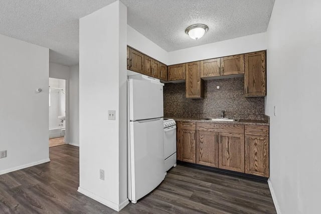 White refrigerator stove wooden cabinets sink kitchen at Marcy Park Student Housing Co-op in Minneapolis Student Accommodation