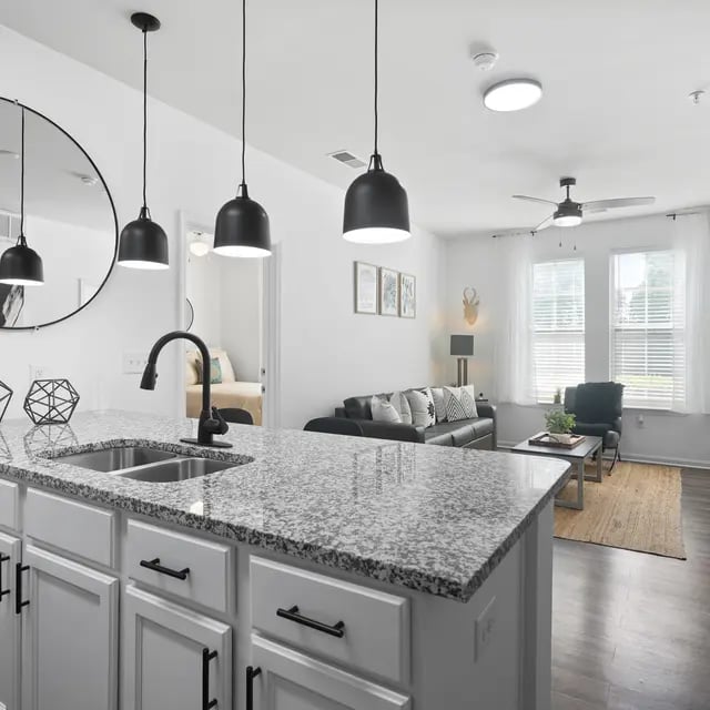 Granite island black faucet white cabinets living room at Millennium One Apartments in Charlotte Student Accommodation