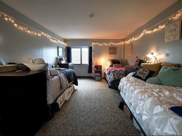Two beds desks and string lights bedroom at Greenwich Court Apartments in State College Student Accommodation