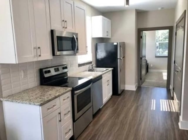 Kitchen with white cabinets refrigerator oven and sink kitchen at Plaza One 89 in Clemson Student Accommodation