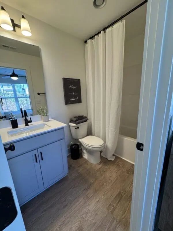 Modern bathroom vanity toilet shower curtain bathroom at Maverick Hills in Central Student Accommodation