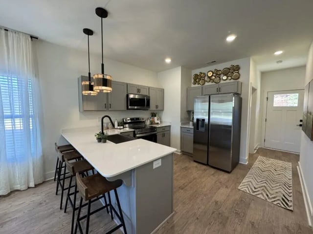 Modern kitchen island refrigerator and pendant lights kitchen at Maverick Hills in Central Student Accommodation