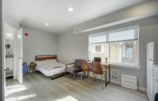 Bed desk chairs and mini fridge studio apartment at Thirty One Apartments in Seattle Student Accommodation