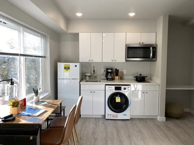 Refrigerator microwave washer and dining table kitchen at Thirty One Apartments in Seattle Student Accommodation