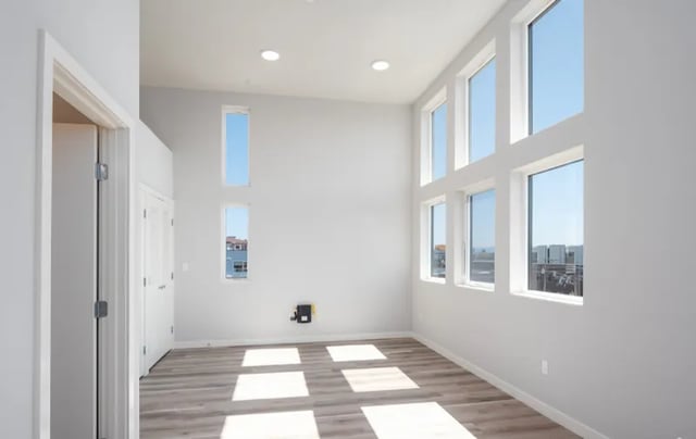 Empty room with tall windows and hardwood floors living room at Thirty One Apartments in Seattle Student Accommodation