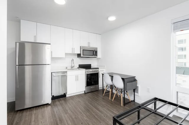 Stainless steel appliances and dining table kitchen at Montclair Apartments in Seattle Student Accommodation