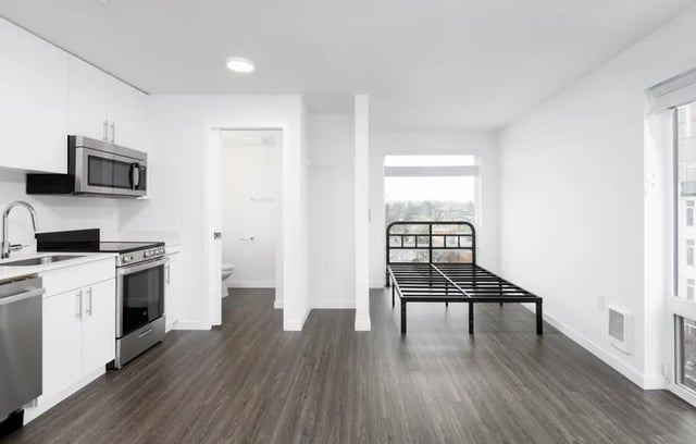 Kitchen bed frame and toilet room studio apartment at Montclair Apartments in Seattle Student Accommodation