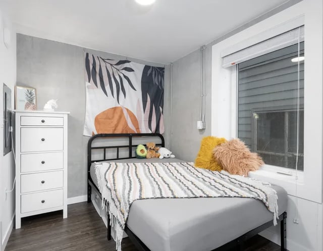 Bed dresser and tapestry bedroom at Montclair Apartments in Seattle Student Accommodation
