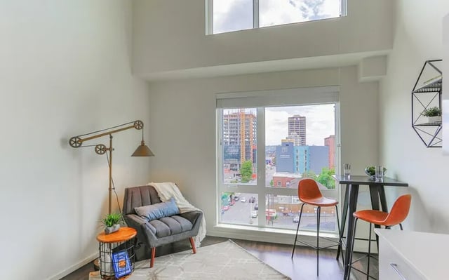 Chair lamp rug and table living room at Montclair Apartments in Seattle Student Accommodation