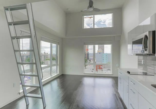 Ladder and kitchen with microwave and windows Living room at Montclair Apartments in Seattle Student Accommodation