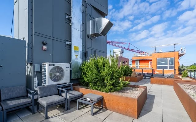 Chairs planters air conditioner exterior at Montclair Apartments in Seattle Student Accommodation