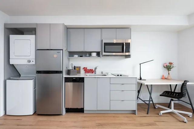 Washer dryer refrigerator dishwasher microwave desk and chair kitchen at Montclair Apartments in Seattle Student Accommodation