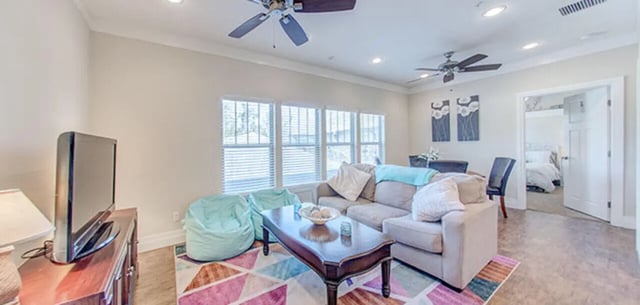 Sofa beanbags coffee table TV living room at Greystone Luxury Apartments in Gainesville Student Accommodation