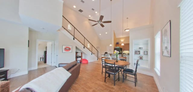 Brown sofa dining table and chairs living room at Greystone Luxury Apartments in Gainesville Student Accommodation