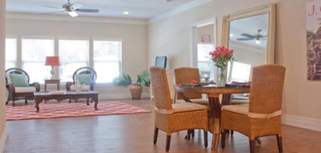 Wicker chairs coffee table dining table living room at Greystone Luxury Apartments in Gainesville Student Accommodation