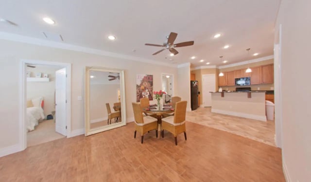 Dining table with chairs mirrored kitchen living room at Greystone Luxury Apartments in Gainesville Student Accommodation