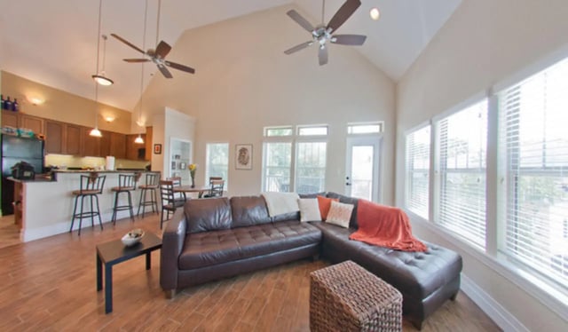 Leather sofa kitchen island bar stools dining table living room at Greystone Luxury Apartments in Gainesville Student Accommodation