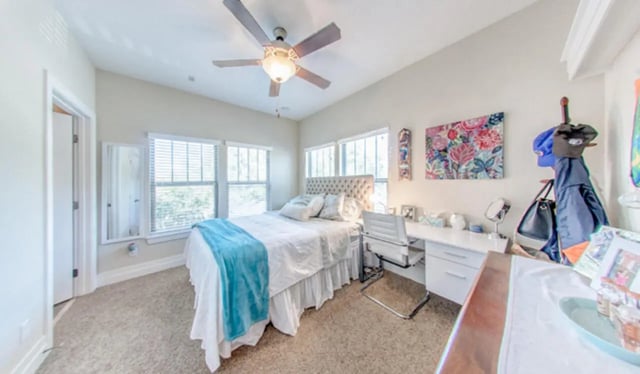 Bed with teal throw and desk study area at Greystone Luxury Apartments in Gainesville Student Accommodation