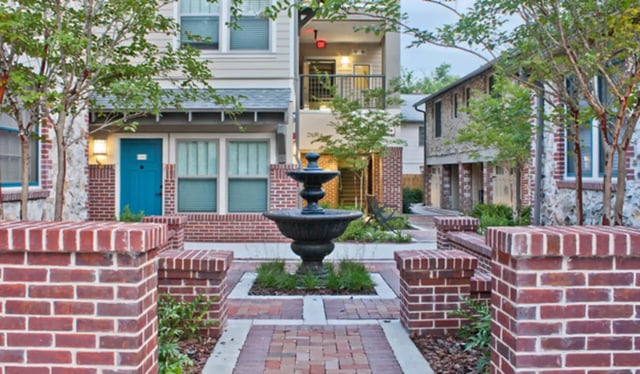 Fountain with brick walkway courtyard exterior at Greystone Luxury Apartments in Gainesville Student Accommodation