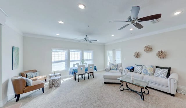 Chairs table sofa and art living room at Greystone Luxury Apartments in Gainesville Student Accommodation