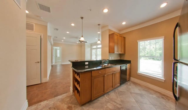 Kitchen with wood cabinets and island kitchen at Greystone Luxury Apartments in Gainesville Student Accommodation