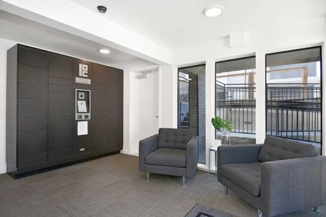 Package lockers and armchairs in lobby. at U20 Apartments in Seattle Student Accommodation